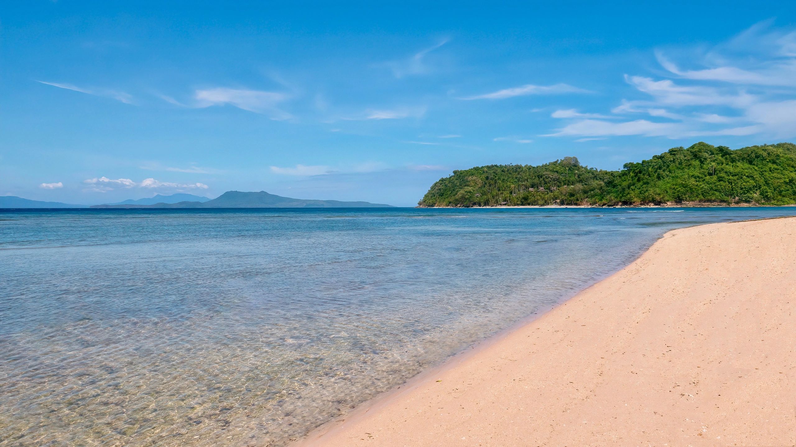Puerto Galera beach with clear turquoise water and tropical shoreline in the Philippines